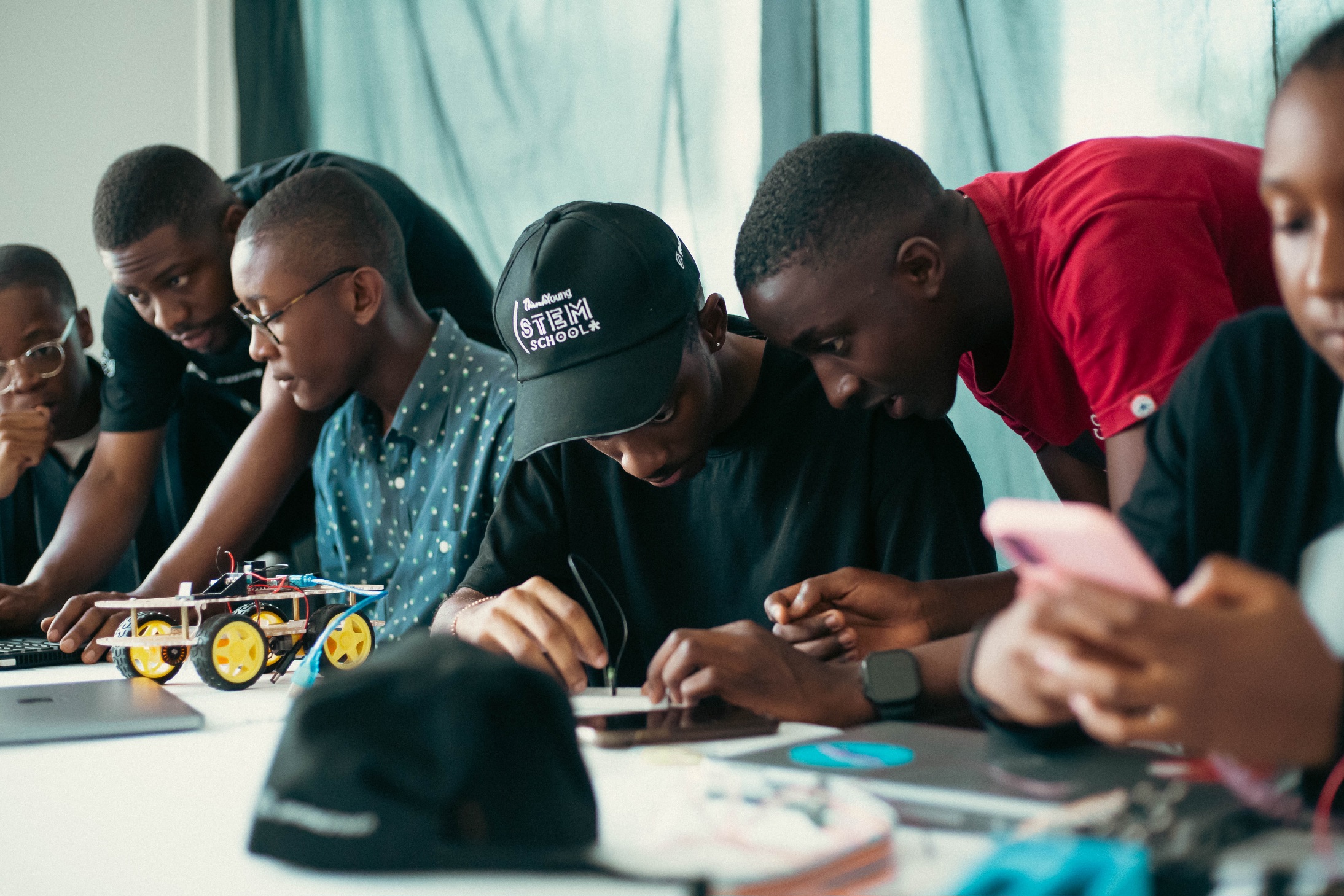 Teachers helping students develop their projects during the ThinkYoung STEM School in Angola